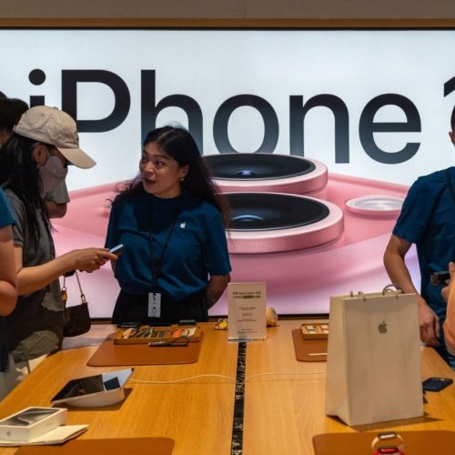 Employees assist customers at an Apple Inc. store during the first day of sale of the iPhone 15 smartphone in Beijing, China, on Friday, Sept. 22, 2023. Apple's latest iPhones and watches went on sale today, a test of whether a new smartphone design and modest smartwatch changes can help return the company to growth. Photographer: Andrea Verdelli/Bloomberg